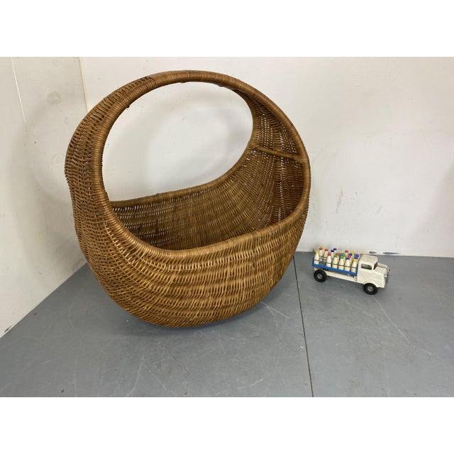 Beautiful oversized mid century hand woven wicker basket. This basket is most likely made by gebr. Jonkers Noordwolde. It...