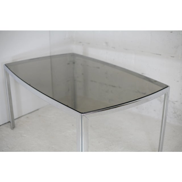 Living room table. Chrome-plated metal, curved smoked glass slab, France, circa 1970. Wear consistent with age: 3 almost...