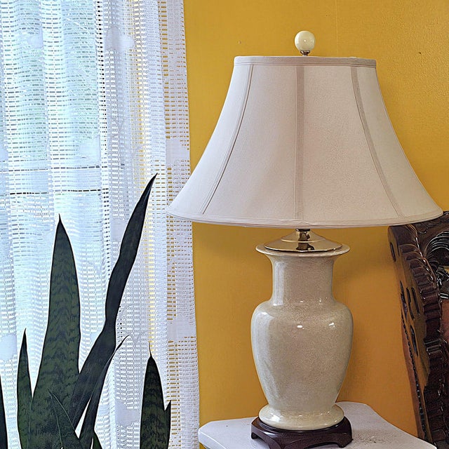 Vintage ivory speckled ceramic table lamp featuring a graceful ginger jar form, glossy glaze, brass-tone fittings, dark...