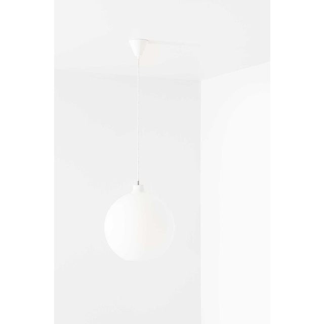 The satellit ceiling lamp, designed by vilhelm wohlert and produced by louis poulsen in denmark, is a refined embodiment...