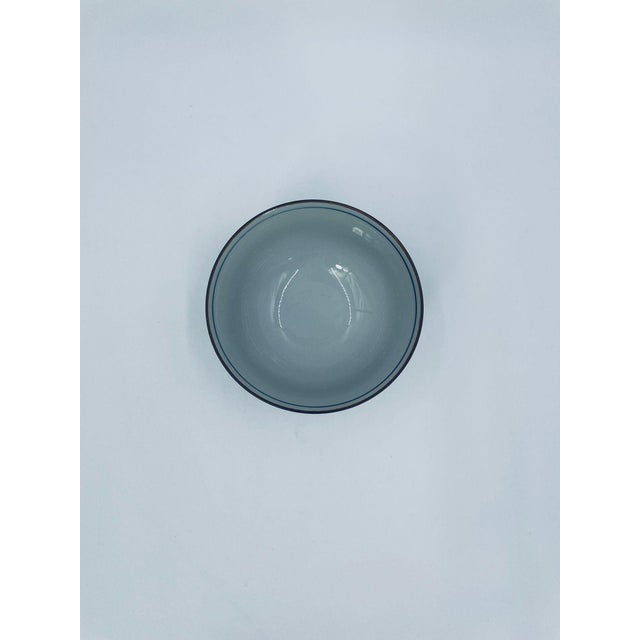 A traditional Japanese rice bowl in the Arita style, crafted from high-quality porcelain. The bowl features a classic,...