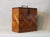 THis is a standing rectangular wooden box from the Arts and Crafts period, featuring finely executed geometric inlays in...