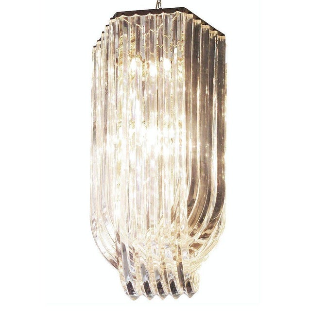 Large mid-century Hollywood Regency Modern sculptural Lucite loop chandelier is comprised of three rows of twisted 2-inch...