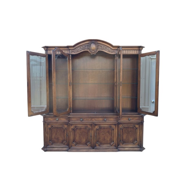 Quick Hits Brand: Karges Furniture Style: French Regency, Louis XVI Materials: Carved burled walnut, glass front doors,...