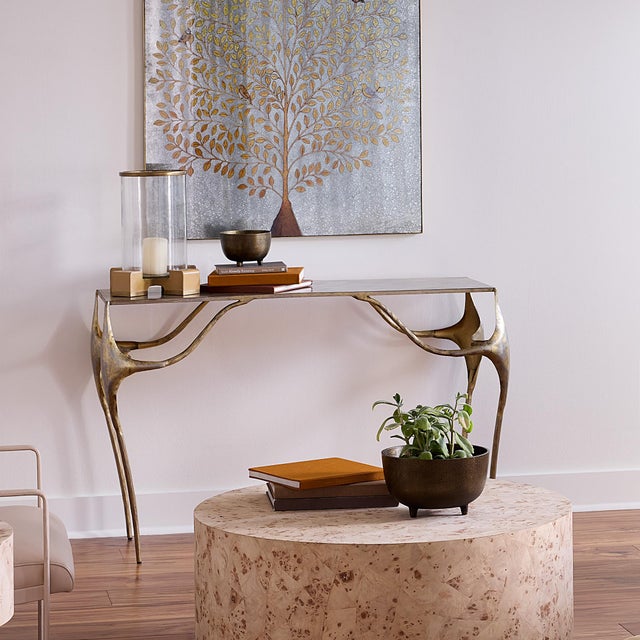 With graceful lines and glowing brass tones, this designer console table infuses your home with quiet sophistication....