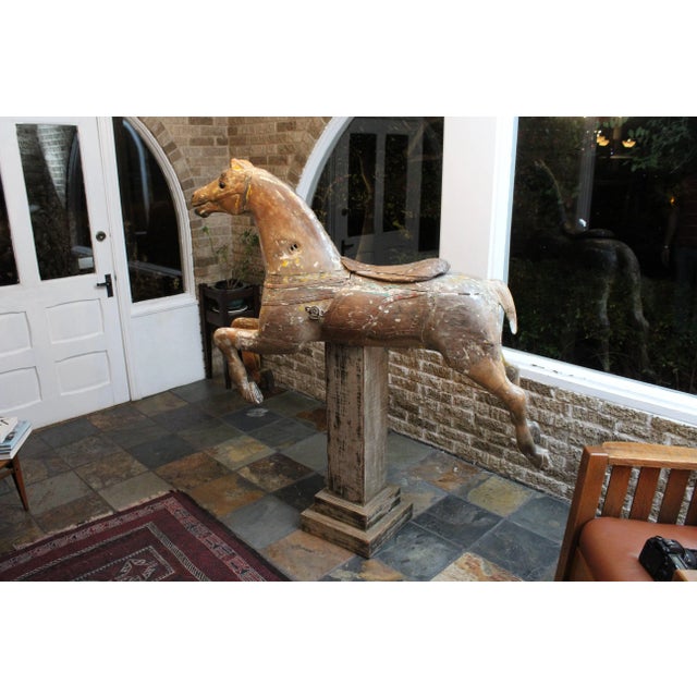 An amazing decorative statement; this charming wood carved carousel horse shows character with traces of its original...