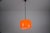 This modern pendant lamp features a smooth, rounded shade in a striking, translucent orange finish that brings warmth and...