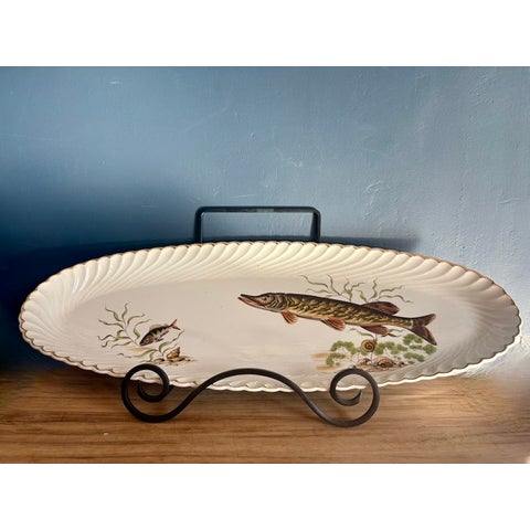 A mid-century French service à poisson from Keller & Guérin, Lunéville, decorated with freshwater fish among water plants,...