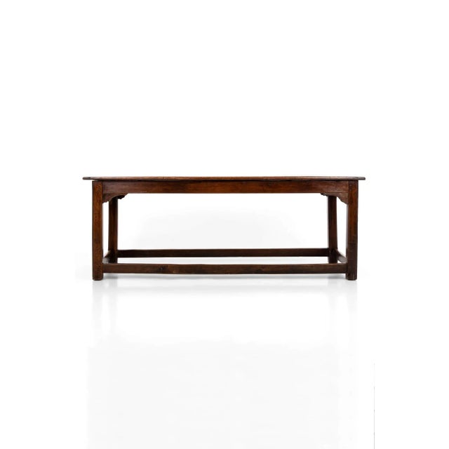 A commanding early 19th Century oak farmhouse refectory table. Heavy two-plank top with breadboard ends, resting on a...