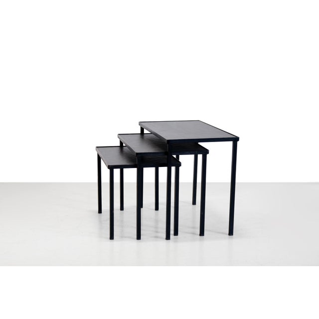 Beautiful, slender Mid-Century modern nesting table set made of black metal with slate tops. This set is by Dutch designer...