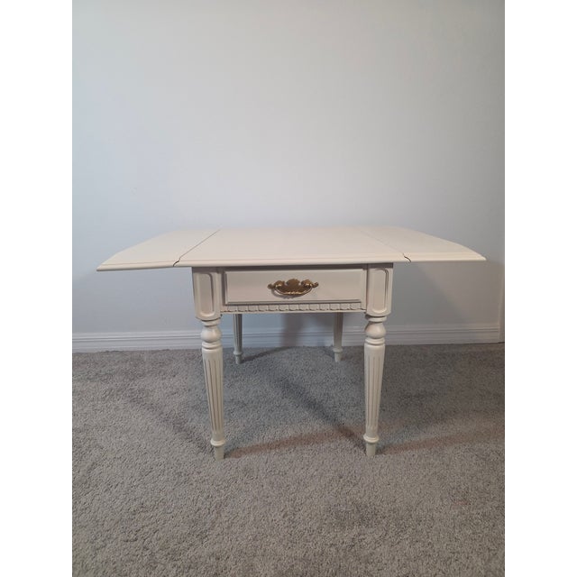 Classic Ethan Allen drop-leaf accent table, professionally refinished in a soft off-white tone that complements both...