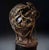 A striking sculpture by René Hetzel, depicting a fragmented male bust, pierced and encircled by an interlacing of bronze...