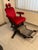 Authentic old barber chair featuring a solid cast iron frame and red velvet upholstery. Equipped with an adjustable...
