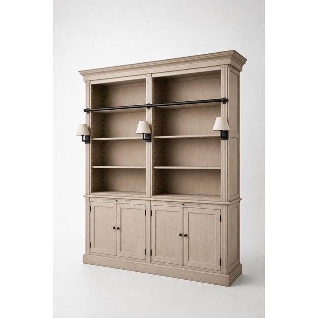 Elegant and timeless library cabinet by Charrell Home Interiors, executed in a refined light oak finish and complete with...