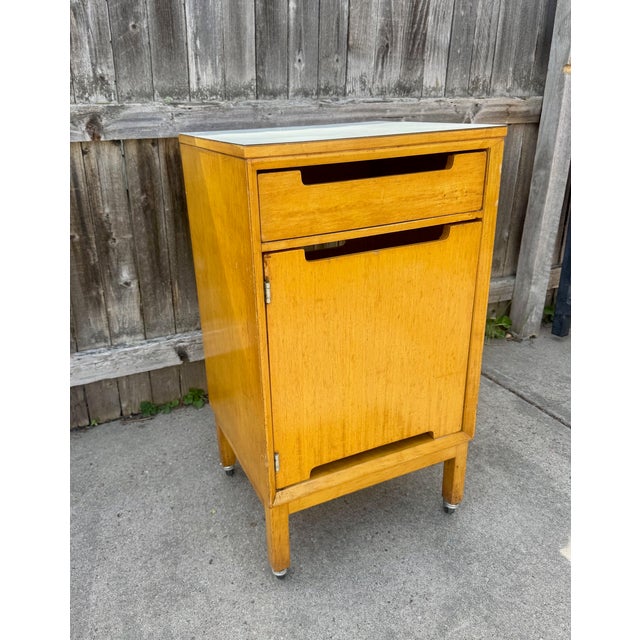 Vintage 1960's rolling hospital bedside cabinet in beech wood with formica top. Similar to Raymond Loewy hospital tables...