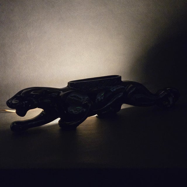 A staple of Mid-Century design, this black ceramic panther is dual purpose, acting as both a vase or small planter and a...