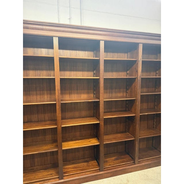 Impressive large-scale library bookcase crafted from solid elm wood, featuring a timeless architectural design with...