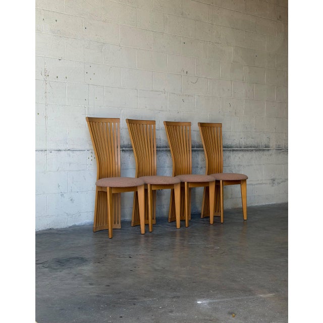 Curved slatted backrests extend down to the floor on this striking set of four dining chairs. Highback silhouettes create...
