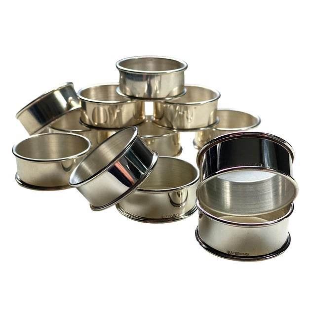 Classic sterling silver round napkin rings. Rolled edges and marked Sterling on exterior; no other decoration. High shine,...