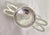 A george vi sterling silver loose tea strainer, hallmarked sheffield 1948. The strainer features a corded border...