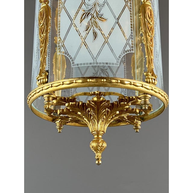 Elegant Louis XVI style gilt bronze lantern, finely chased with neoclassical motifs, ribbons, and acanthus leaves. It is...