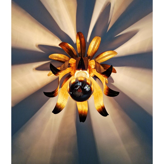 Italian ceiling light in gilt metal, floral design, 1960s-70s. Restored/rewired. Compatible with an E27 LED bulb. Some...