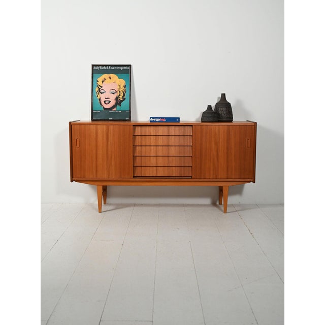 1960s teak sideboard with tiled central drawers and side doors. A 1960s Scandinavian teak sideboard with elegant and well-...