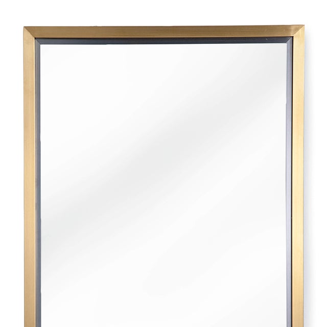 With its subtle natural brass frame and minimalist design, this rectangle mirror adds a finished touch to any room.
