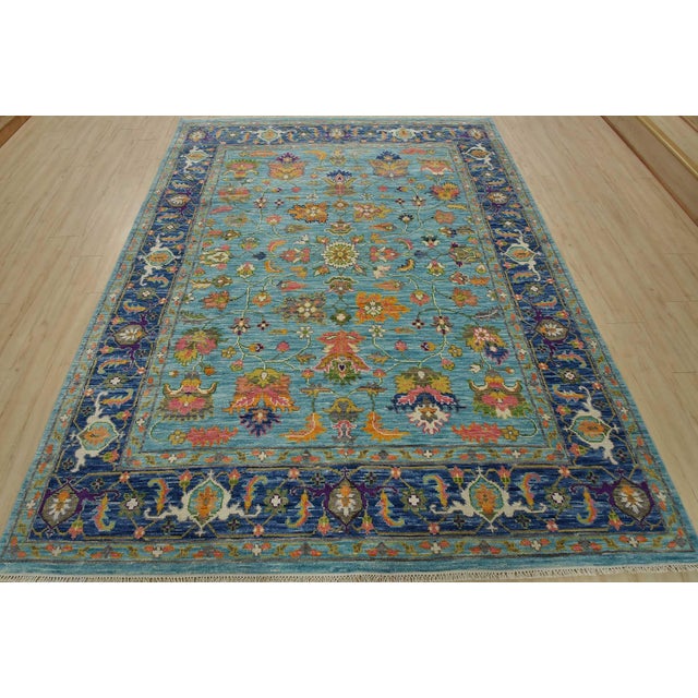 A modern traditional Anatolia rug hand-knotted with an all-wool pile on a cotton foundation. This oriental rug features an...