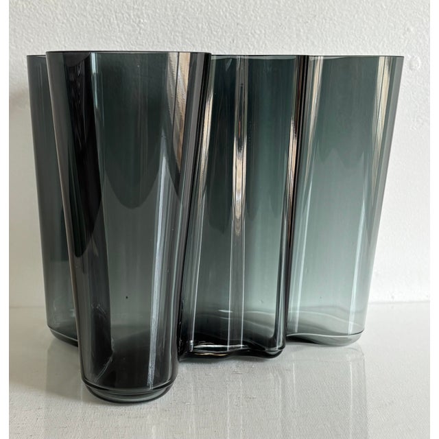 Designed in 1936, this iconic Scandavian Iittala glass vase, by Finnish architect and designer Alvar Aalto, is held in...