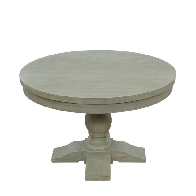 This Restoration Hardware round dining table features the brand’s signature weathered oak finish paired with a substantial...