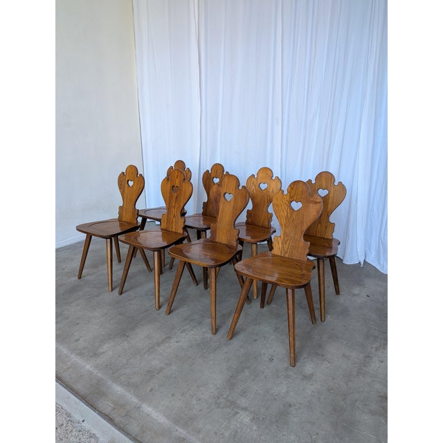 Vintage wooden dining chairs in traditional Tyrolean (Alpine) style. with a shaped backrest and characteristic heart cut-...