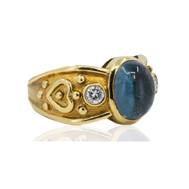 18k ring by Keith Davis with one 4.03 carat cabochon tourmaline and 2 round diamonds weighing 0.22 carats. 8.56 grams Size...