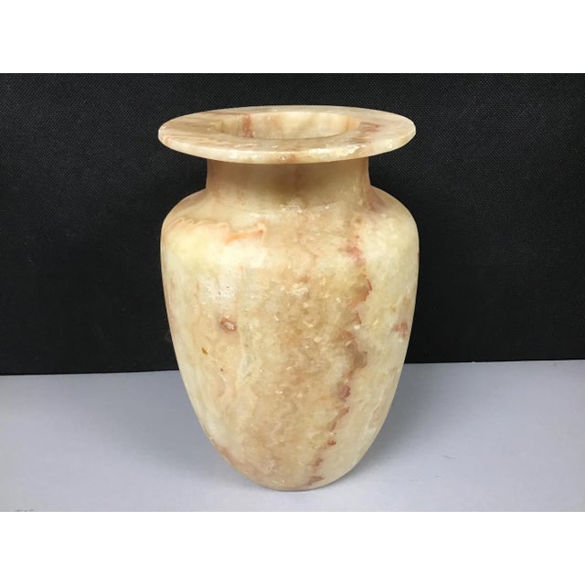 Beautiful hand carved alabaster Egyptian vase. This lovely and translucent piece has remarkable depth and color that glows...
