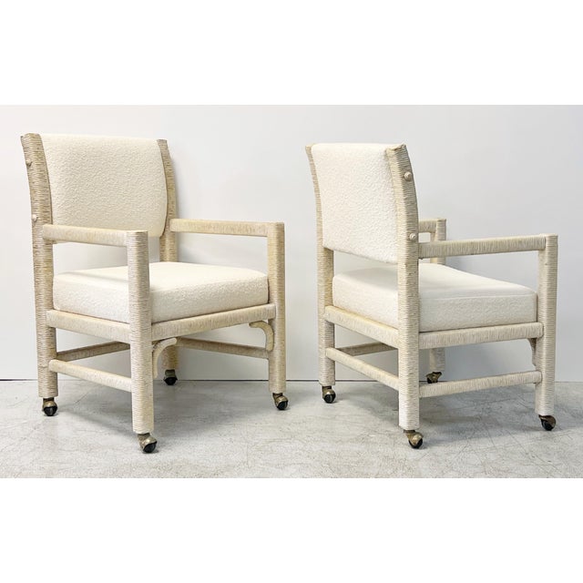 A pair of well proportioned and interesting chairs. The wood frames are wrapped in paper cord. New boucle upholstery....