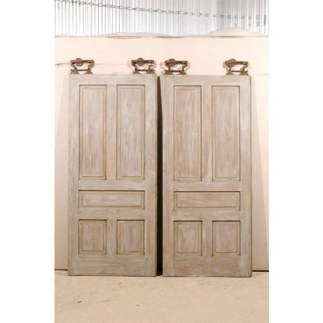A pair of early 20th century American pocket doors with their original hanging hardware. This pair of early 20th century...