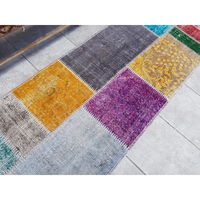 This is a vintage Turkish Oushak rug from the Mid 20th Century. The piece was hand-knotted.