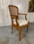Very elegant sculptural cane armchair with carved floral accents. The curved back makes this very more comfortable than a...