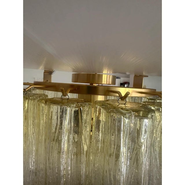 Scenographic italian hand-made flush mount with clear amber “tronchi” , elements of murano glass. elegant flush mount in a...