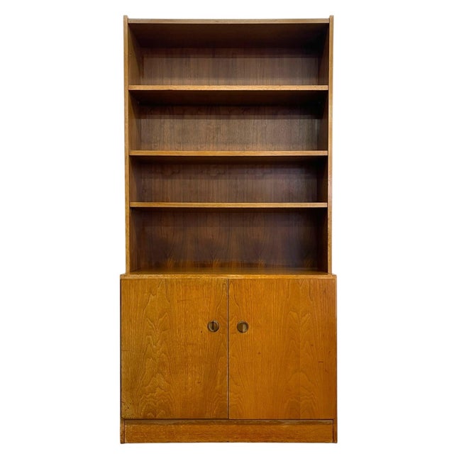 Vintage mid century modern bookcase cabinet featuring an open shelving upper section and enclosed lower storage...