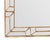 Crafted with a metal frame finished in hand-applied gold leaf, this striking mirror features a sophisticated geometric...