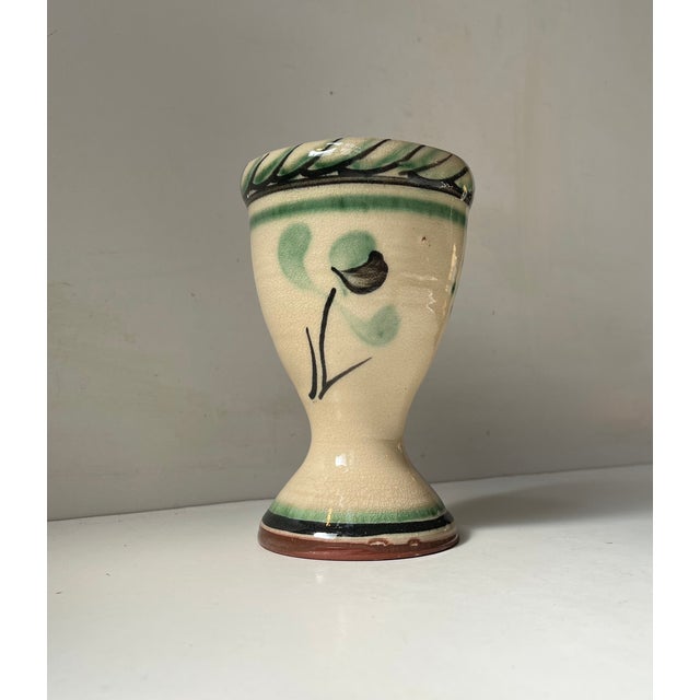 Pedestal vase or small planter in hand-glazed pottery. Decorated with stylized flower and ribbon. Signed by an unknown...