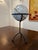 Small tabletop world globe with soft pastel coloring and a dark bronze iron tripod stand. The globe can be removed from...