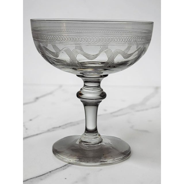 Engraved Crystal Champagne Coupes – Late 19th/Early 20th Century Beautiful engraved crystal champagne coupes with a...