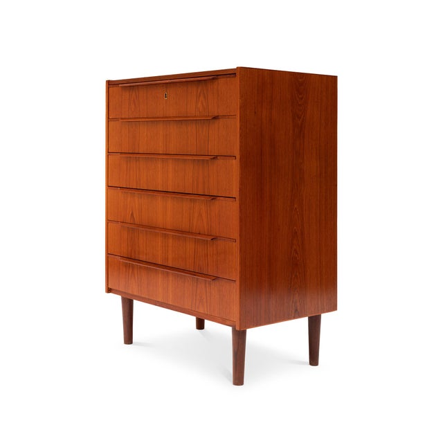This stunning 1960s Danish Mid-Century teak tallboy dresser is a timeless piece of craftsmanship. Featuring exquisite wood...