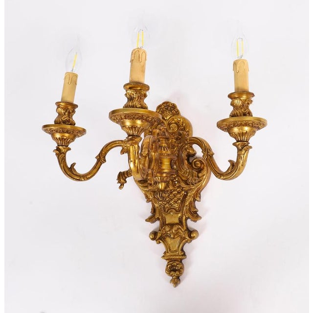 This is a fine antique set of eight French Baroque revival ormolu wall lights, circa 1900 in date. They feature shaped...