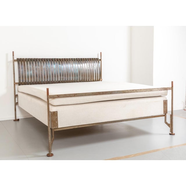 Double bed with steel frame, wooden feet and caps, and headboard with steel springs. Literature DOMUS 301 (December 1954),...