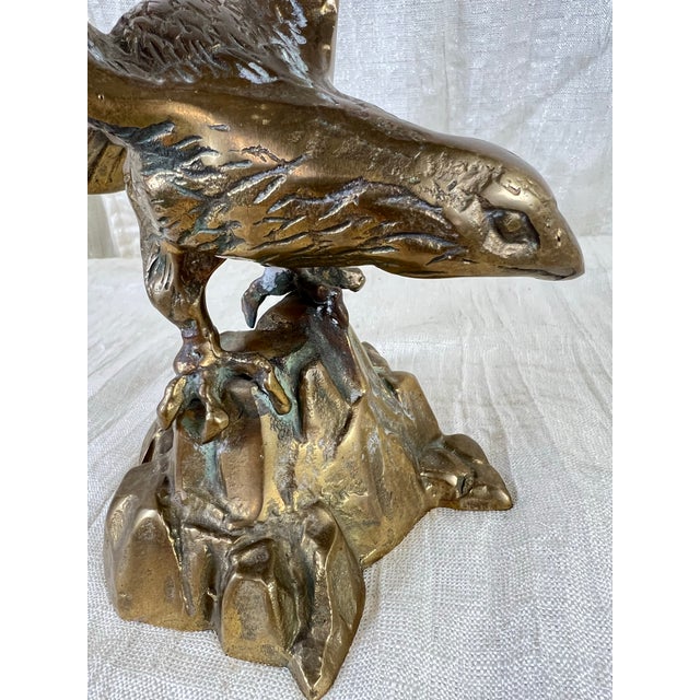 Bring timeless craftsmanship and dramatic movement to your home with this vintage solid cast brass eagle sculpture....