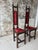 A striking pair of vintage prayer chairs featuring richly turned wood detailing, deep oxblood velvet upholstery, and hand-...