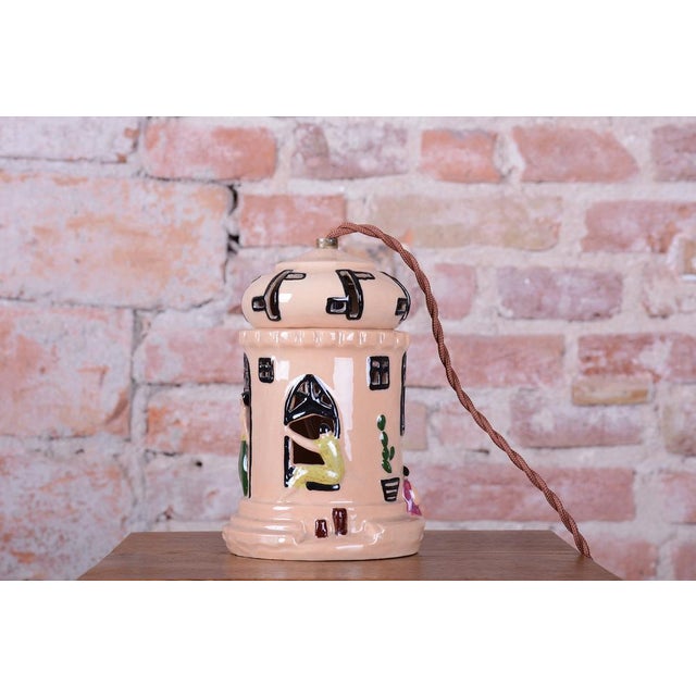 This decorative table lamp originates from France in the 1980s and represents a playful example of ceramic art that...